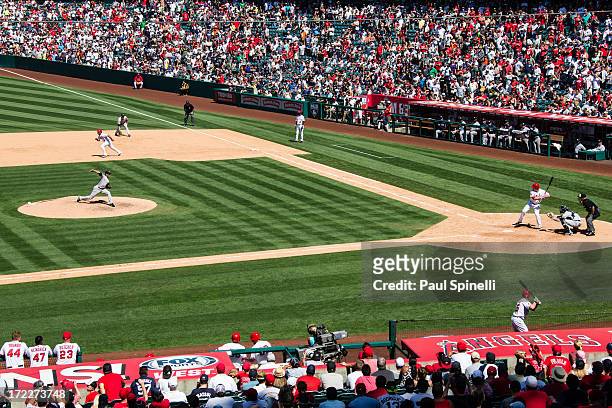 Mariano Rivera of the New York Yankees pitches to Brad Hawpe of the Los Angeles Angels of Anaheim as Alberto Callaspo of the Los Angeles Angels of...