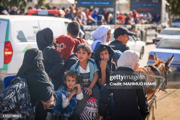 Palestinians with their belongings leave Gaza City as they flee from their homes following the Israeli army's warning on October 13, 2023....