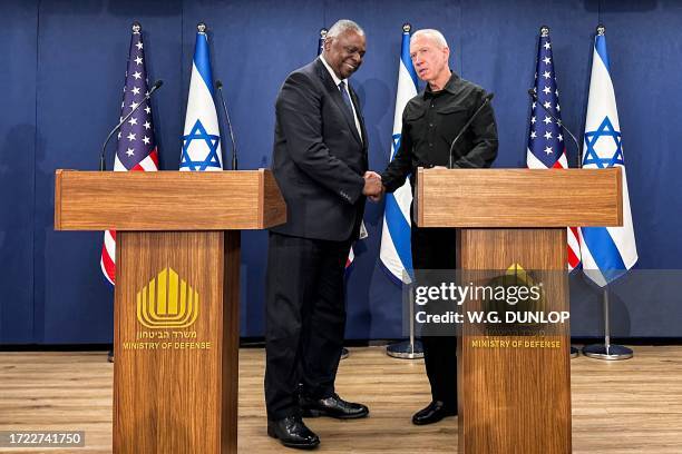 Secretary of Defense Lloyd Austin shakes hands with Israel's Defence Minister Yoav Gallant after a joint press conference in Tel Aviv on October 13,...