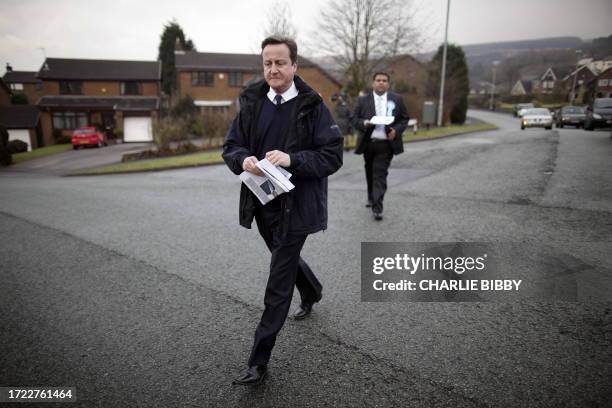 British Prime Minister David Cameron campaigns with local candidate Kashif Ali in the Shaw area at Oldham East and Saddleworth, north-west England,...