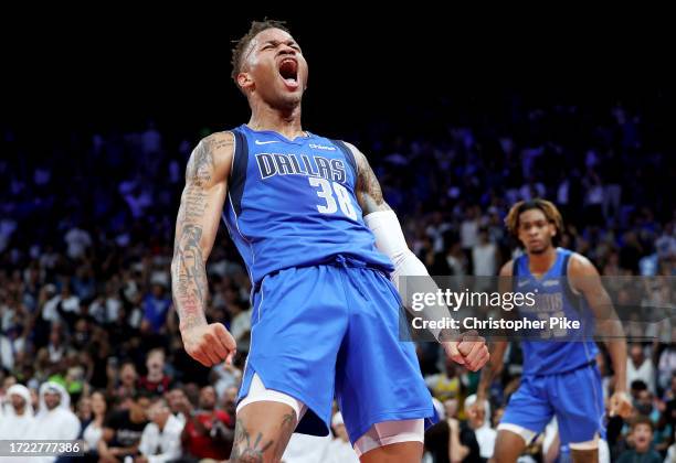 Dexter Dennis of the Dallas Mavericks celebrates scoring during the second half of the preseason NBA game between Minnesota Timberwolves and Dallas...