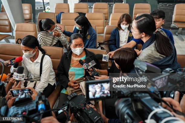 Family members of a Thai worker evacuated from Israel wait for the arrival of evacuees from Israel, at Suvarnabhumi Airport in Samut Prakan province,...