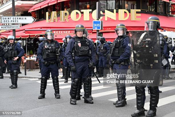 French Republican Security Corps police officers stand guard during a demonstration as part of a nationwide day of strike called by France's...