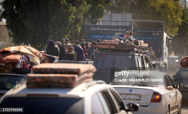 Palestinians with their belongings flee northern Gaza City following the Israeli army's warning to leave their homes before an expected ground...