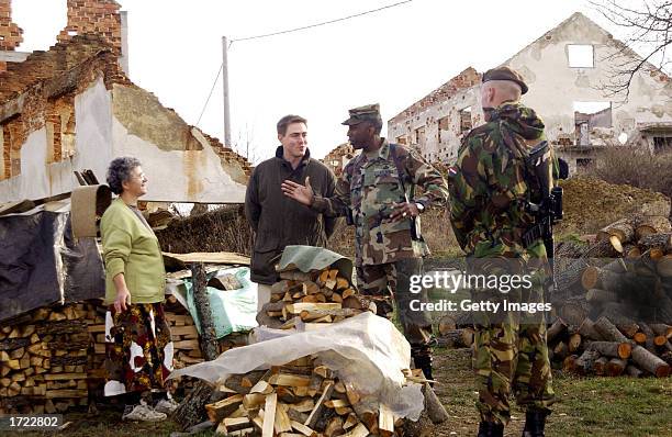 Lt. Gen. William E. Ward , Commander of Stabilization Force , talks with a resident of a rebuilt home whlie on patrol with members of the Dutch...