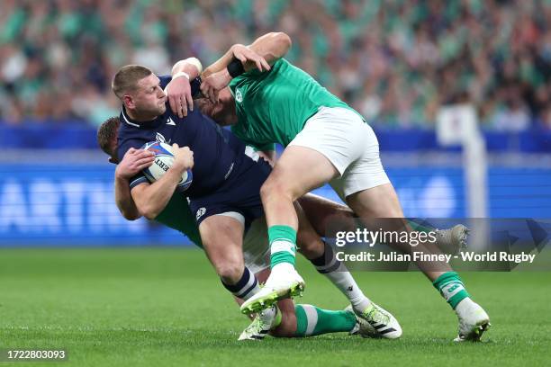 Finn Russell of Scotland is tackled by Dan Sheehan and Tadhg Furlong of Ireland during the Rugby World Cup France 2023 match between Ireland and...