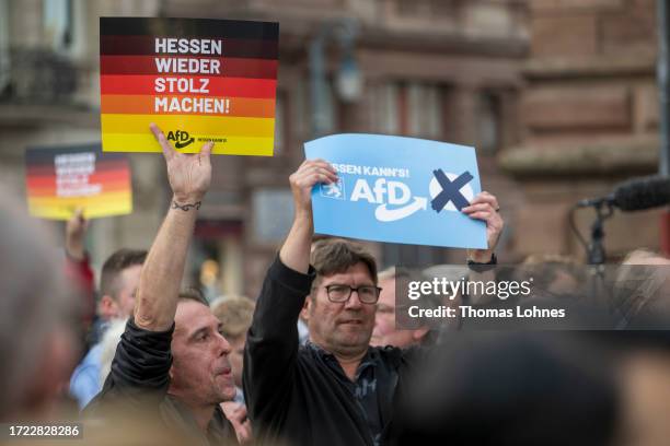 Supporters holt poster during the final AfD election campaign rally ahead of Hesse state elections on October 07, 2023 in Wiesbaden, Germany. The AfD...