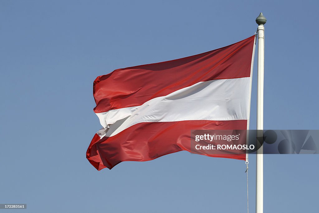 Austrian flag against blue sky, Austria