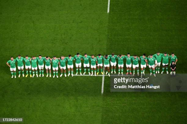 Players of Ireland line up during the National Anthems prior to the Rugby World Cup France 2023 match between Ireland and Scotland at Stade de France...