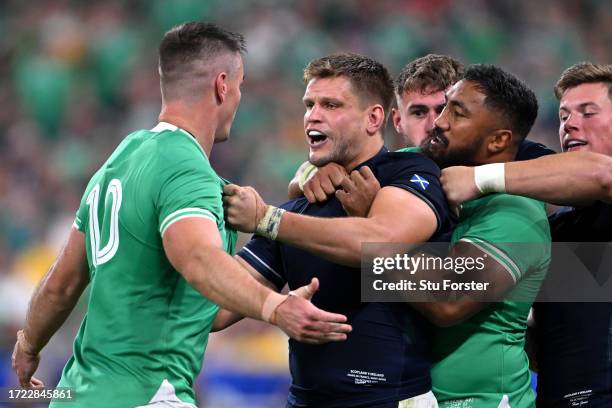 Johnny Sexton of Ireland clashes with George Turner of Scotland, who is held back by Bundee Aki of Ireland, during the Rugby World Cup France 2023...