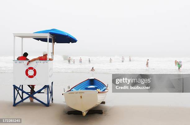 lifeguards at work - beach shelter stockfoto's en -beelden