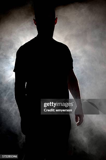 silhouette of man in a cloud of smoke - spooky smoke stock pictures, royalty-free photos & images