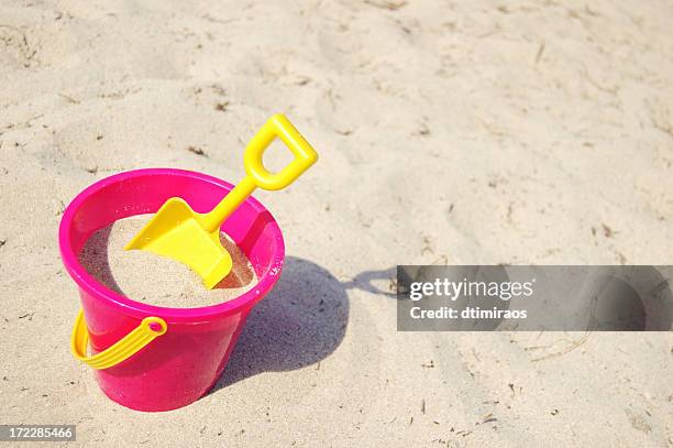 pink bucket and yellow shovel in the sand - beach goers stock pictures, royalty-free photos & images