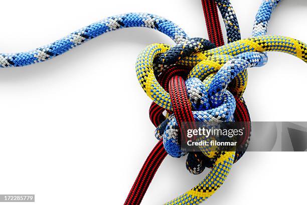 close-up of multicolored gordian knot on white background - complex stockfoto's en -beelden