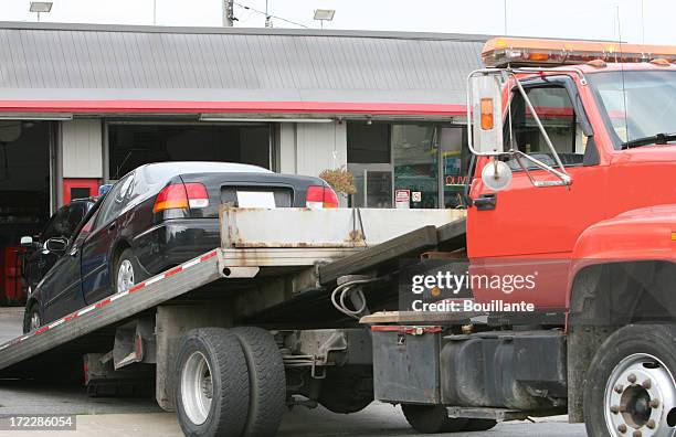 black car on a red flat bed tow truck - car towing stock pictures, royalty-free photos & images