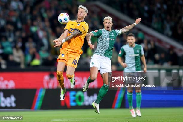 Marco Friedl of Werder Bremen challenges Wout Weghorst of TSG 1899 Hoffenheim during the Bundesliga match between SV Werder Bremen and TSG Hoffenheim...