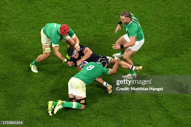 Rory Darge of Scotland is tackled by Caelan Doris of Ireland whilst under pressure from Josh Van der Flier and Finlay Bealham of Ireland during the...