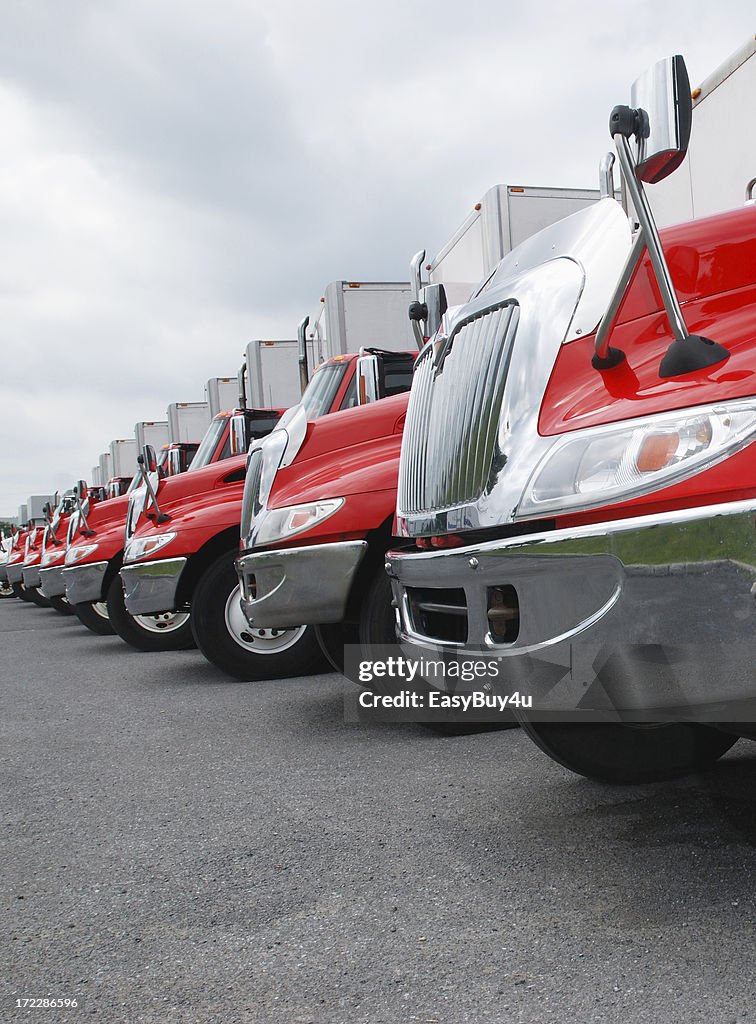 Line of parked red and shiny trucks