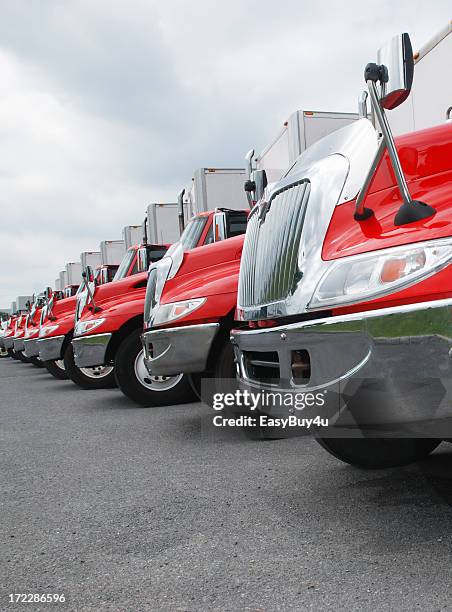 line of parked red and shiny trucks - convoy stock pictures, royalty-free photos & images