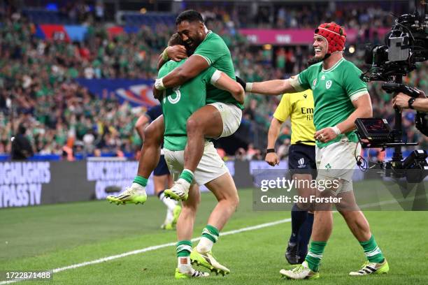 Garry Ringrose of Ireland celebrates scoring his team's sixth try with teammate Bundee Aki during the Rugby World Cup France 2023 match between...