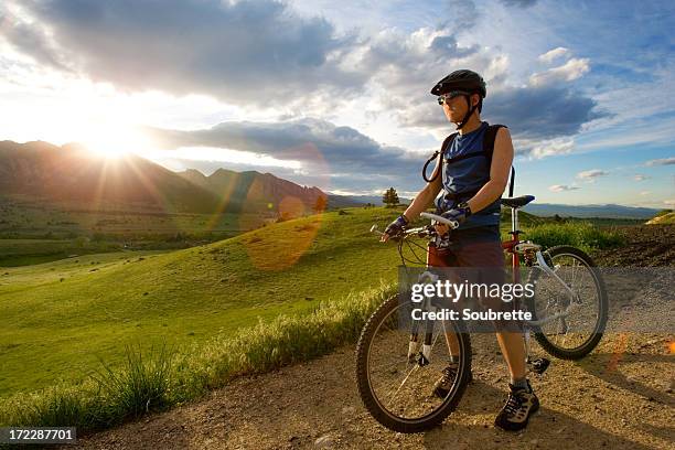 a man standing in a dirt road with a bike - boulder colorado stock pictures, royalty-free photos & images