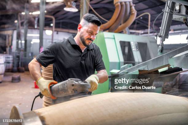 in a cooperage in jerez, the master cooper refines and polishes the american oak wood with sandpaper and rotaflex. - sherry stock pictures, royalty-free photos & images