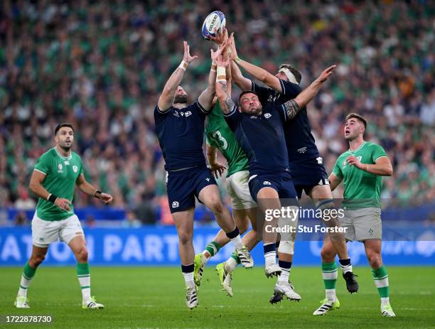 Ewan Ashman, Rory Sutherland and Scott Cummings of Scotland contends for the aerial ball with Garry Ringrose of Ireland during the Rugby World Cup...