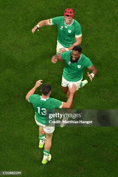 Garry Ringrose of Ireland celebrates scoring his team's sixth try with teammate Bundee Aki and Josh Van der Flier of Ireland during the Rugby World...