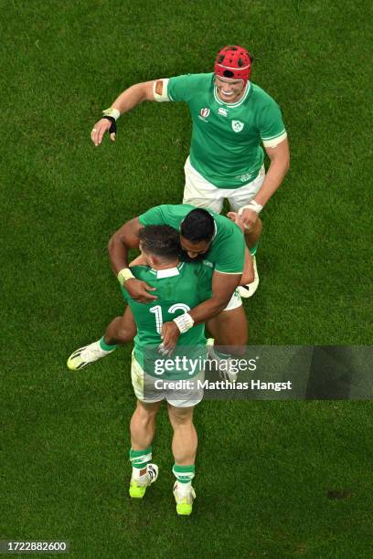 Garry Ringrose of Ireland celebrates scoring his team's sixth try with teammate Bundee Aki and Josh Van der Flier of Ireland during the Rugby World...