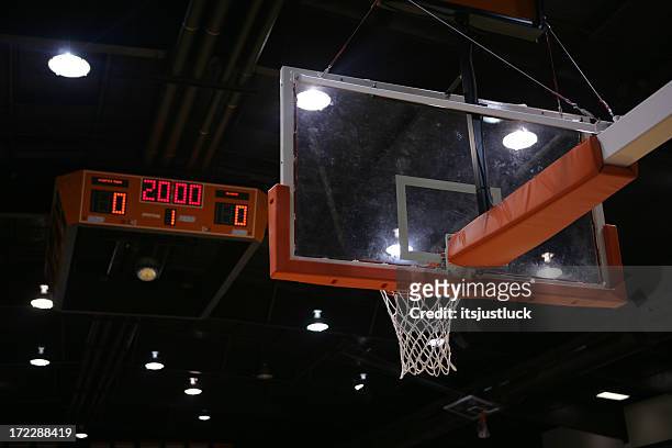 a basketball hoop and a scoreboard above that  - basketball scoring stock pictures, royalty-free photos & images