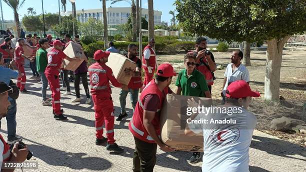 Workers load the trucks with boxes after a planes carrying Turkish humanitarian aid for residents of the Gaza Strip landed at El Arish International...