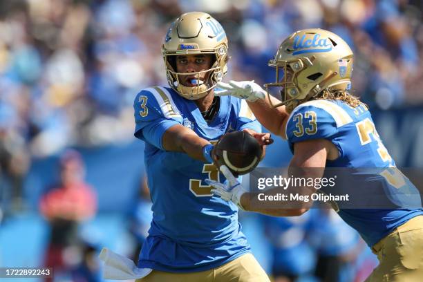 Dante Moore hands off to Carson Steele of the UCLA Bruins in the first quarter against the Washington State Cougars at Rose Bowl Stadium on October...