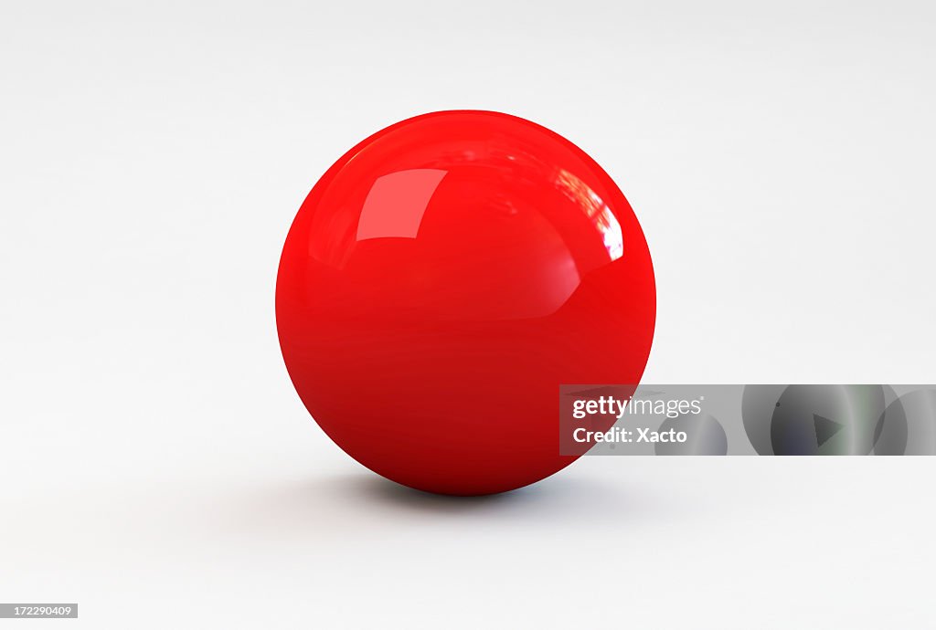 A shiny red ball with shadow on a white background