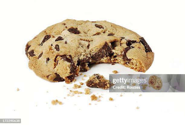 close-up of a chocolate chip cookie with a bite - chocolate chip cookie on white stock pictures, royalty-free photos & images