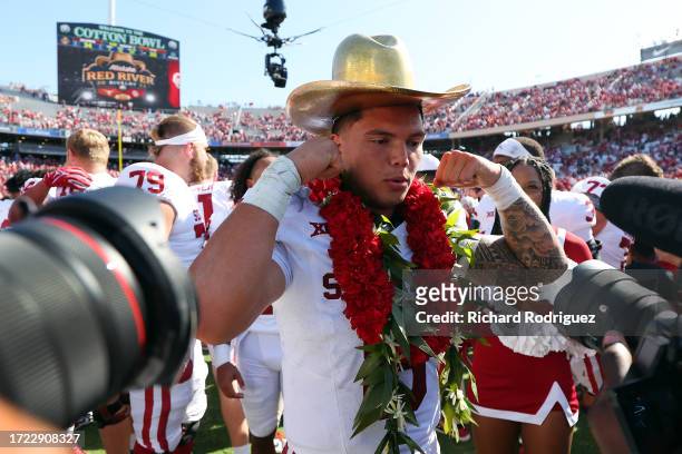 Quarterback Dillon Gabriel of the Oklahoma Sooners wears the Golden Hat as he flexes for the cameras after the win over the Texas Longhorns at the...