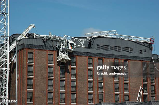fallen scaffolding on top of a brown building - building site accidents stock pictures, royalty-free photos & images