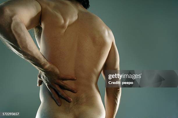male holding hand to point of back pain. - back pain 個照片及圖片檔