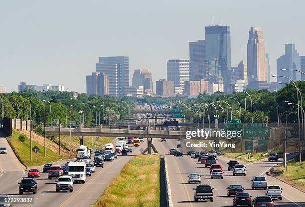 busy traffic on multiple lane highway with minneapolis, minnesota skyline - minnesota skyline stock pictures, royalty-free photos & images