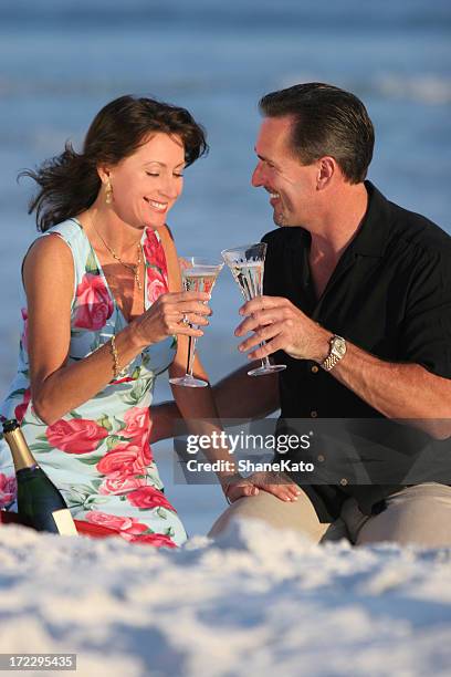 couple celebrating on beach - destin stock pictures, royalty-free photos & images