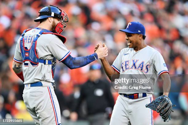 Jonah Heim reacts with Jose Leclerc of the Texas Rangers after the final out during the ninth inning of Game One of the American League Division...