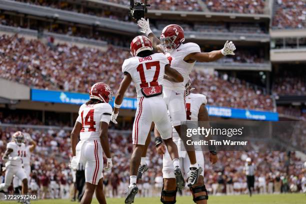 Isaiah Bond of the Alabama Crimson Tide is congratulated after a touchdown reception in the first half against the Texas A&M Aggies at Kyle Field on...