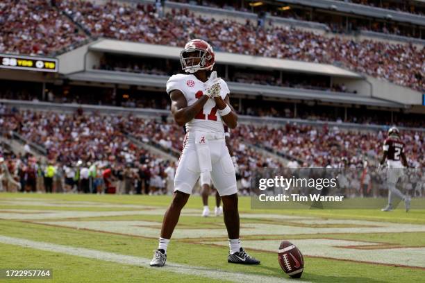 Isaiah Bond of the Alabama Crimson Tide celebrates after a touchdown reception against the Texas A&M Aggies in the first half at Kyle Field on...