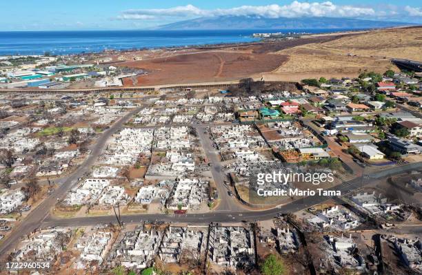 In an aerial view, burned homes and cars are seen near homes which did not burn nearly two months after a devastating wildfire on October 07, 2023 in...