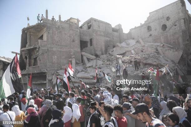 People, holding Palestinian flags, gather to stage Pro-Palestinian demonstration in Damascus, Syria on October 13, 2023.