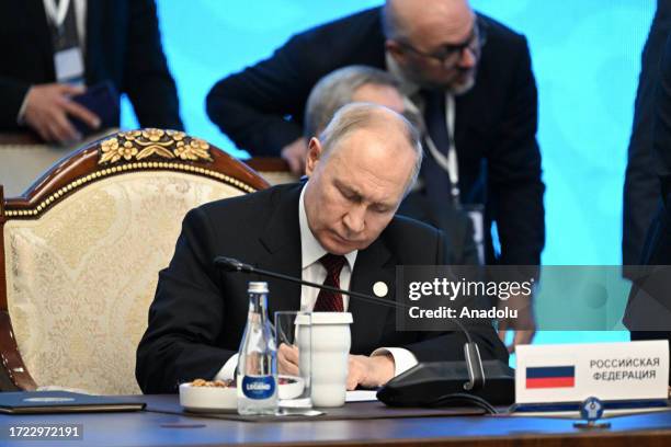 Russian President Vladimir Putin signs the agreements 'Establishment of the international risk assessment center on proceeds of crime and financing...