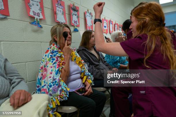 Optometry students administer vision tests to patients for a free pair of eyeglasses at a Remote Area Medical mobile dental and medical clinic on...