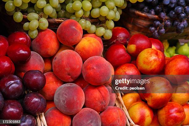 a selection of many fruits in a market - plum stock pictures, royalty-free photos & images