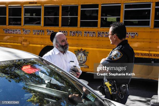 Member of the New York Police Department patrols in front of a synagogue on October 13, 2023 in the Williamsburg neighborhood in the borough of...