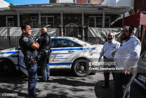 Members of the New York Police Department patrol in front of a synagogue on October 13, 2023 in the Williamsburg neighborhood in the borough of...