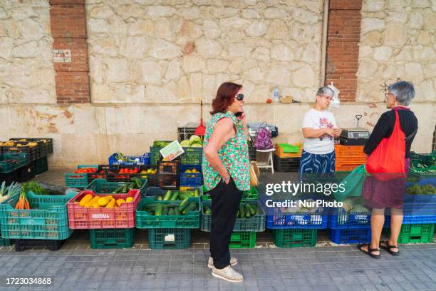 Women buying fruit and vegetables outside the Abastos market in the medieval city of Zamora